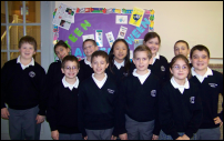 Photograph: Woodridge Tweenangels in front of one of their project displays